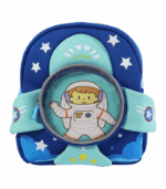 Primer plano de una mochila infantil de color azul oscuro y turquesa con un diseño frontal que simula un cohete espacial y un astronauta de dibujos animados dentro de un visor circular.